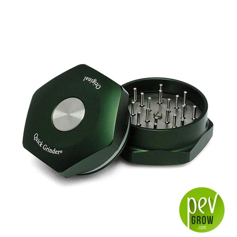 Quick Grinder Original verde oscuro abierto, con púas metálicas visibles y tapa apoyada de lado con un disco plateado central.