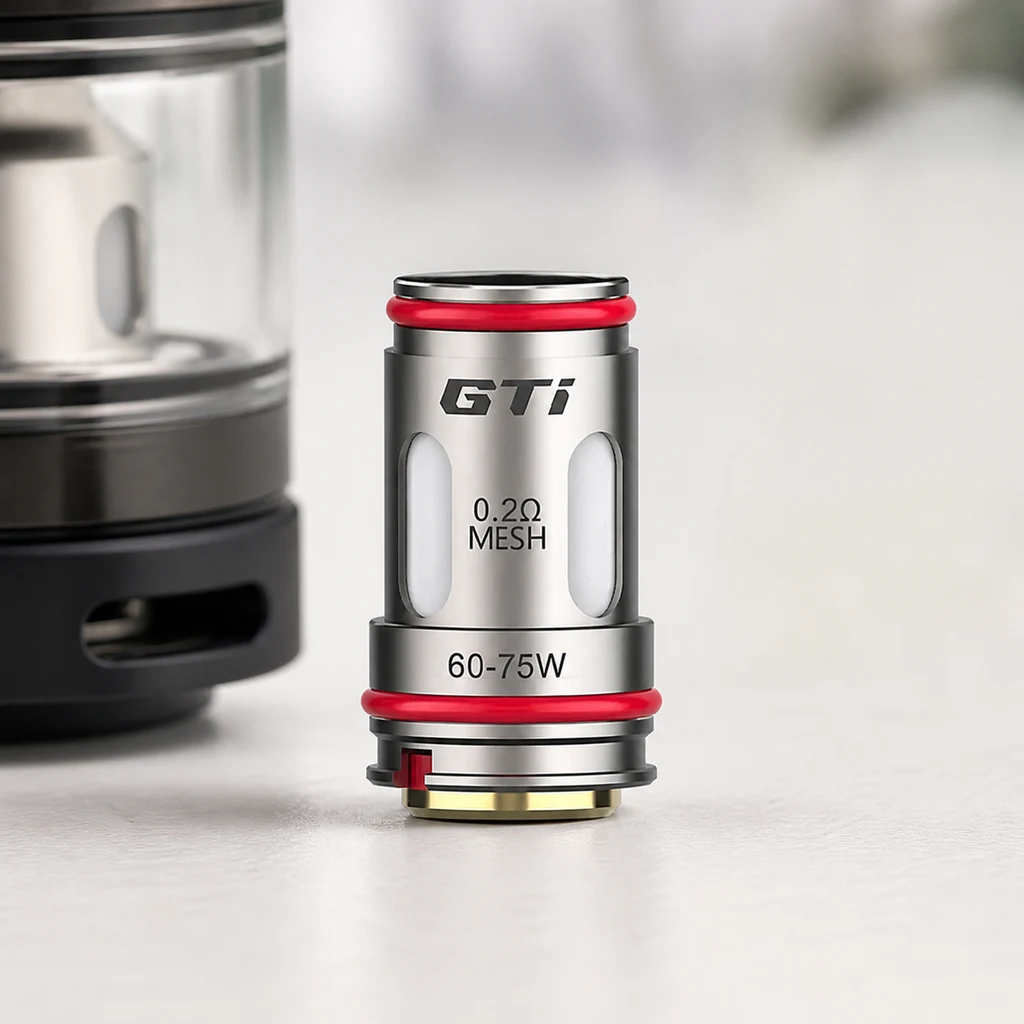 Resistencia GTi de Vaporesso con juntas rojas e inscripciones 0,2 Ω Mesh y 60–75 W, junto a un depósito parcialmente visible. Resistencia GTi de Vaporesso con juntas rojas e inscripciones 0,2 Ω Mesh y 60–75 W, junto a un depósito parcialmente visible.