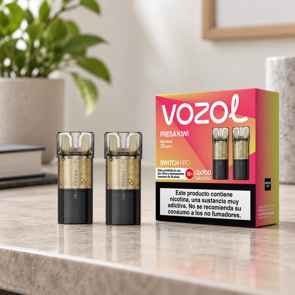 Pods Vozol Switch Pro Fresa Kiwi junto a su caja rosa y naranja sobre una encimera, con una planta desenfocada al fondo.