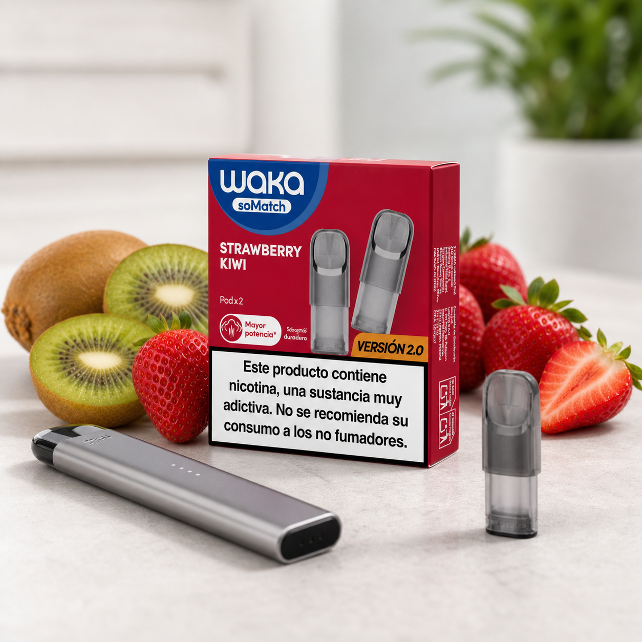 Caja Waka soMatch Strawberry Kiwi versión 2.0 junto a un dispositivo gris y un pod suelto, rodeados de fresas y kiwis.