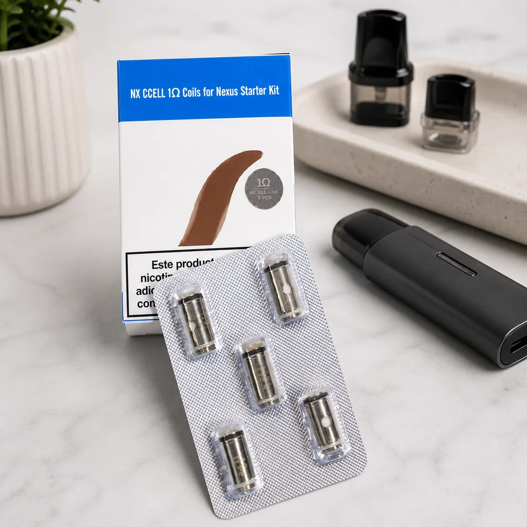 Resistencias Vaporesso Nexus CCELL de 1 Ω en blíster junto a su caja, con un vapeador negro y cartuchos al fondo. Resistencias Vaporesso Nexus CCELL de 1 Ω en blíster junto a su caja, con un vapeador negro y cartuchos al fondo.