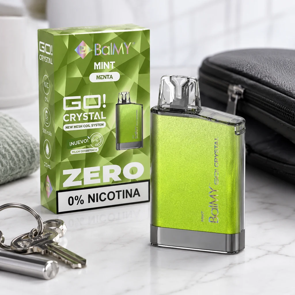 Vaper Balmy Go Crystal Mint verde con boquilla transparente junto a su caja, rotulada «0% nicotina», sobre una superficie clara.