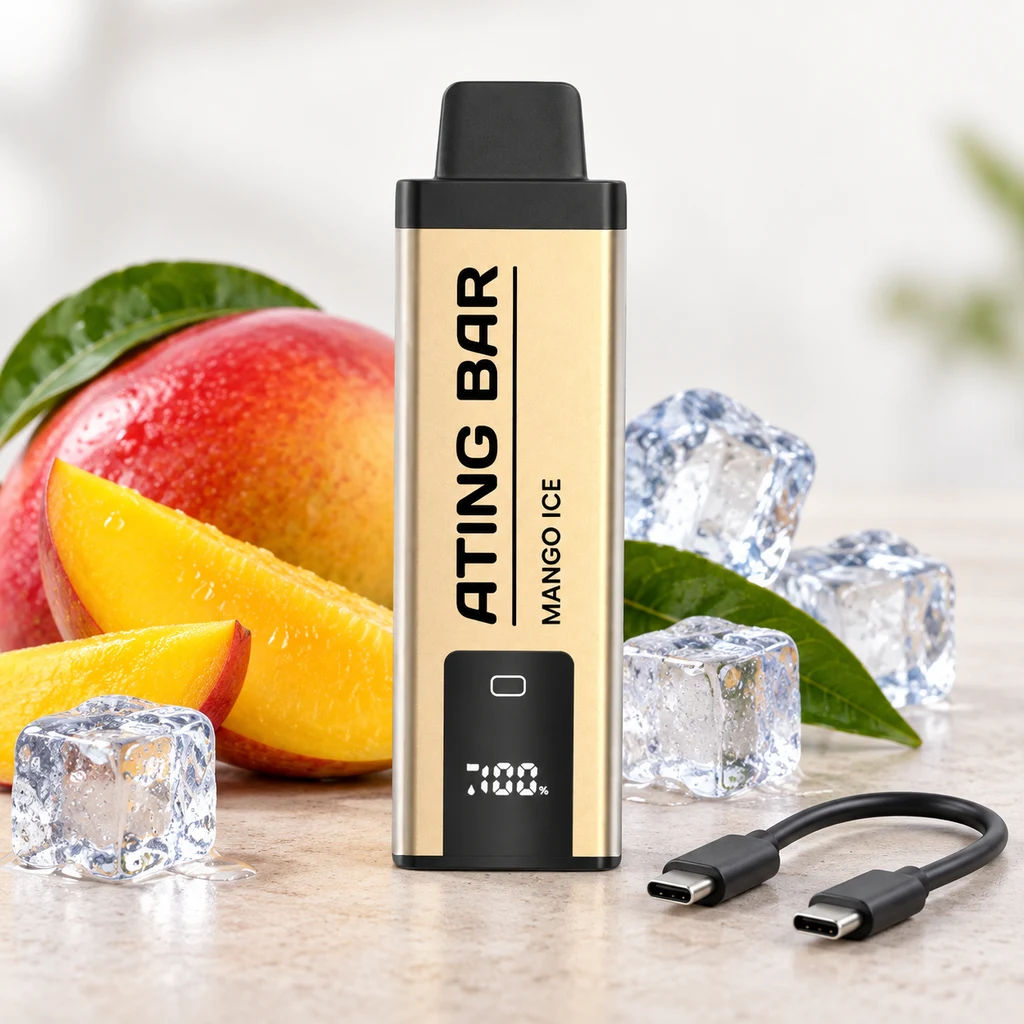 Vaper Ating Mango Ice dorado con boquilla negra y pantalla frontal, junto a mango cortado, cubitos de hielo y un cable USB-C.