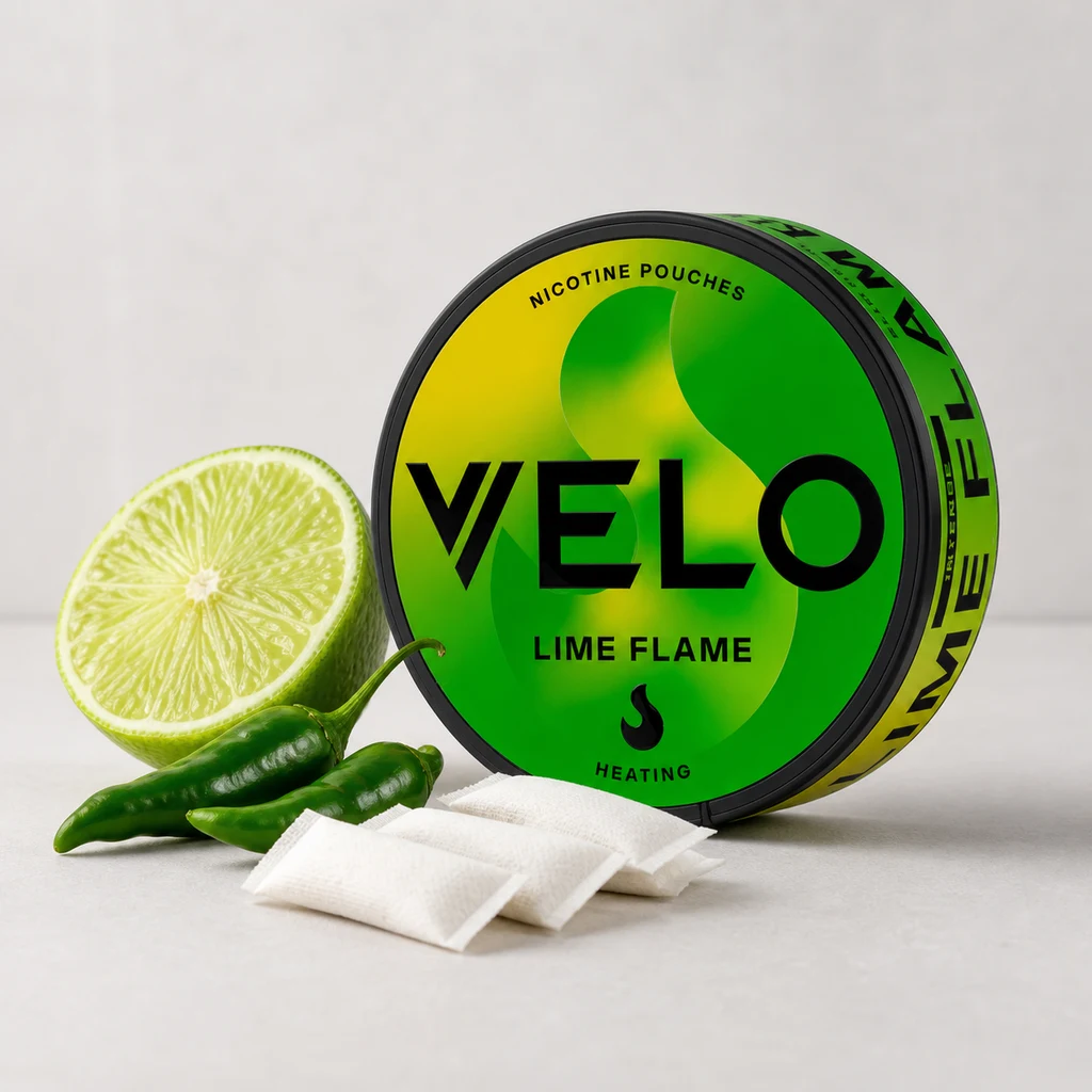 Escena generada de una lata verde y amarilla VELO Lime Flame junto a bolsitas blancas, media lima y chiles verdes.